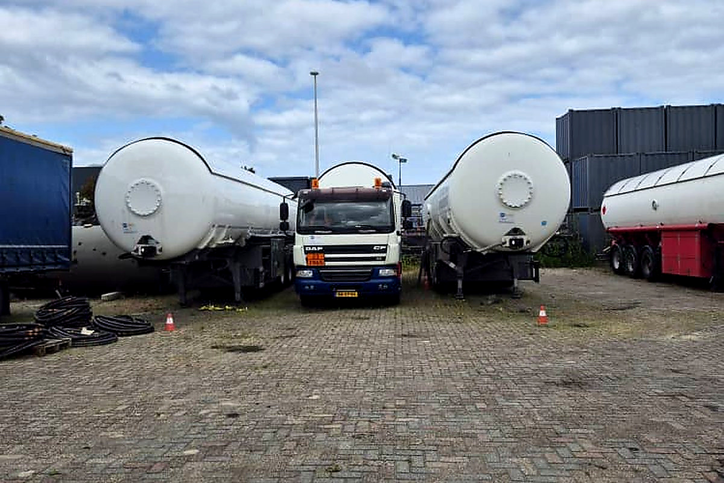 Bomart LPG bridger fleet — three tankers parked between cargo trailers