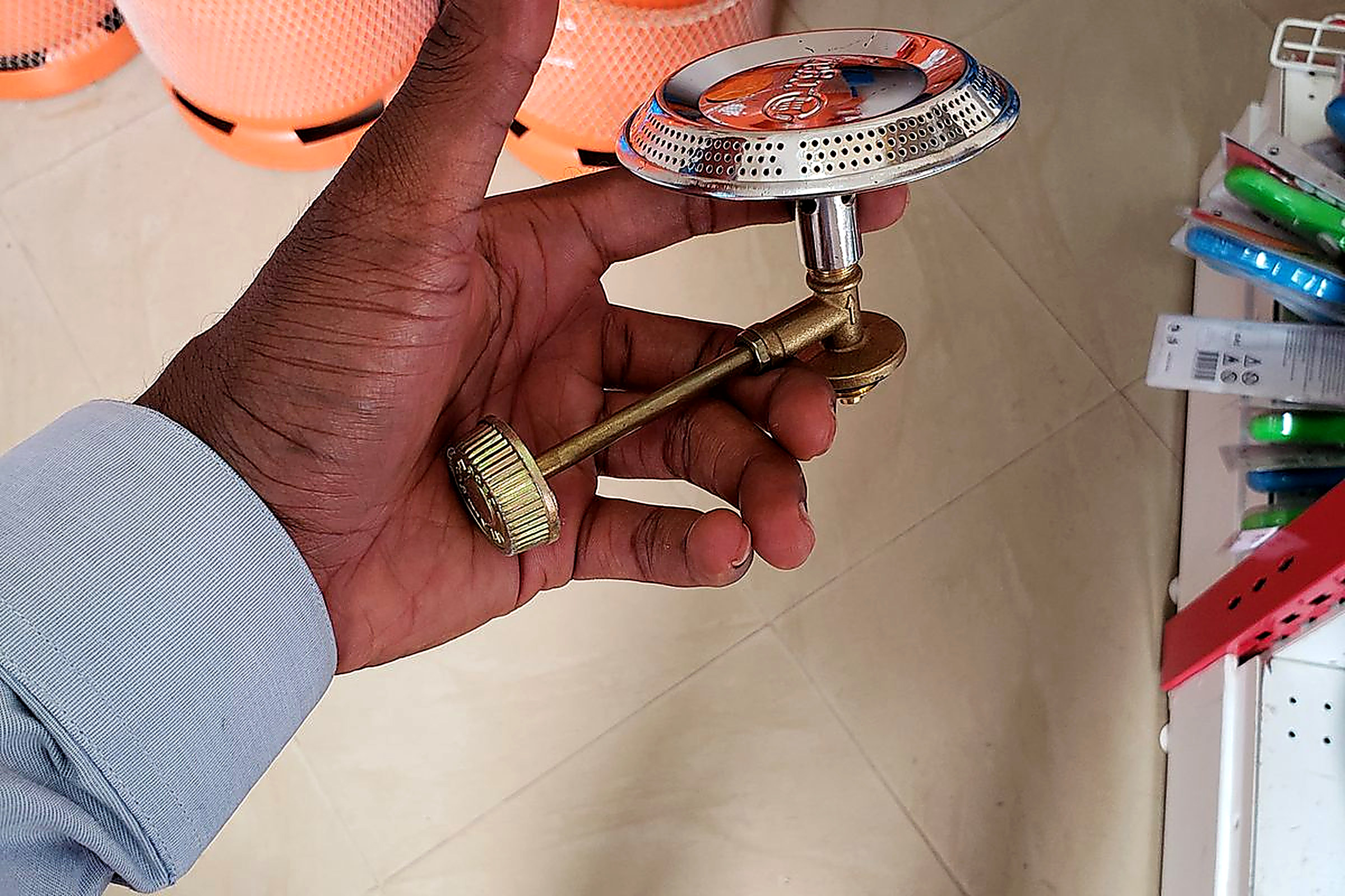 Bomart technician inspecting an LPG burner head before customer delivery